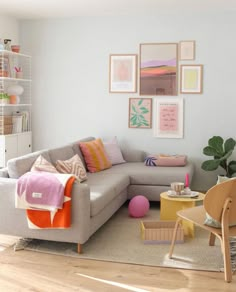 a living room filled with furniture and pictures on the wall