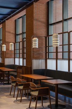 an empty restaurant with wooden tables and chairs