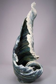 an artistic vase with waves in it on a gray background