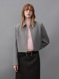 This is a semi-cropped jacket crafted from a wool blend, offering a soft and warm touch with exuding a formal mood.- Semi-oversized fit allowing for various stylings- Features a front zipper closure, adding a casual flair- The jacket's silhouette exuding a minimalistic mood Wool Cropped Outerwear For Office, Modern Cropped Jacket With Zipper For Work, Modern Cropped Jacket With Zipper Closure For Work, Winter Workwear Cropped Jacket With Zipper Closure, Winter Cropped Jacket For Workwear With Zipper Closure, Chic Cropped Wool Outerwear, Wool Cropped Jacket For Winter, Cropped Wool Outerwear For Spring, Winter Wool Cropped Jacket