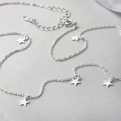 The star charm necklace is an easy win for your style. Martha Jackson's take on the star charm necklace is a delicate sterling silver chain with highly polished and dainty charms adorning it. It sparkles and it shines. Because of the highly polished stars, this sterling silver charm necklace looks great worn solo and also adds some movement and texture to a stacked neck. This is the sort of piece that becomes the summer staple you wear day after day. Sterling Silver Charm Necklace, Silver Charm Necklace, Star Charm Necklace, Matching Bracelet, Dangly Earrings, Affordable Jewelry, Spiritual Jewelry, Matching Bracelets, Recycled Sterling Silver