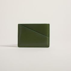 Compact cardholder with geometric design and blocked colors, crafted from natural apple peel and plant-based materials. This unique cardholder is all you need for a quick errand, with just enough space for an ID, cash and ATM cards. The sleek appearance will also complement any outfit. Personalization: Add hand painted letters & make your Allégorie bag more unique Dimensions: Approx. 4" L x 2.8" H Selected Material Certification USDA certification for biobased materials PETA certification for cr Modern Green Wallet For Everyday Use, Minimalist Rectangular Card Holder With Card Slots, Minimalist Rectangular Card Holder With Slots, Modern Green Wallets With Rfid Blocking, Green Rectangular Card Holder For Daily Use, Green Rectangular Wallets With Card Slots, Green Rectangular Wallet With Card Slots, Green Bifold Card Holder With Interior Slots, Modern Rectangular Card Holder For Daily Use