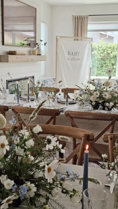 a table with flowers and candles on it