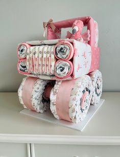 a cake made to look like a toy truck with pink and white ruffles