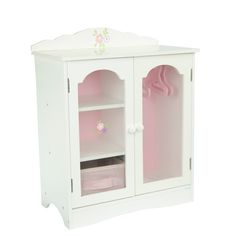 a white wooden doll house with pink accessories on the door and shelves in front of it