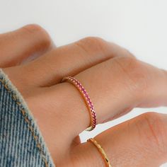 Sweet, simple, and dainty eternity band. Perfect for a minimalist look, or for stacking. ☆ Details ☆ * Made of 925 Sterling Silver * Available in 14k Gold Plating or Rhodium * We use a THICK, DURABLE plating - for a piece that will last you years to come! * VERY HIGH QUALITY * Available in sizes 4, 5, 6, 7, 8, 9, or 10 * Features stones throughout the entire ring * Measures 1.3mm in thickness * Made of Highest Grade Pink/Red CZ stones for an authentic Ruby Look * Also available in White CZ, Sapp Minimalist Half Eternity Band For Everyday, Minimalist Stackable Rings With Prong Setting, Everyday Minimalist Stackable Eternity Band, Pink Minimalist Midi Rings, Dainty Adjustable Half Eternity Jewelry, Dainty Everyday Stackable Rings With Prong Setting, Minimalist Stackable Eternity Band, Everyday Stackable Infinity Rings, Stackable Adjustable Eternity Band