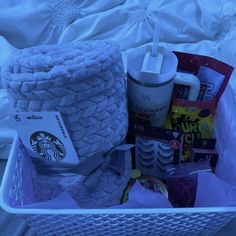 the basket is full of starbucks products and other items