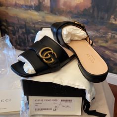 Authentic Gucci Marmont Gg Leather Sandal Brand New Size 36(6) Black Leather Upper Smooth Leather Sole Gold Tone Hardware With Classic Double G Made In Italy Includes Everything Shown Smoke Free Environment Luxury Flat Heel Mules With Buckle Closure, Chic Gucci Flat Sandals, Luxury Flat Slides With Buckle Closure, Designer Round Toe Mules With Buckle Closure, Designer Mules With Buckle Closure And Round Toe, Designer Closed Toe Sandals With Leather Footbed, Elegant Flat Calf Leather Slides, Designer Flat Sandals For Formal Occasions, Gucci Summer Calf Leather Sandals