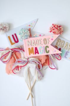 a sign that says made of magic on it next to some hair clips and other items