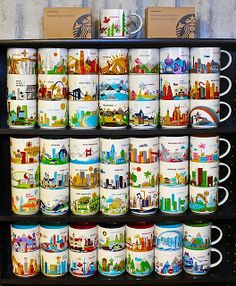 a shelf filled with lots of different kinds of coffee cups on top of each other