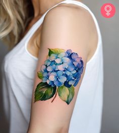 a woman's arm with blue flowers on it