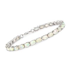 Ross-Simons - Ethiopian Opal Tennis Bracelet in Sterling Silver. 8". Dreamy 6x4mm oval Ethiopian opal cabochons beam with glamorous colorplay in this unique take on a traditional tennis bracelet, set in sterling silver. Lobster clasp, opal tennis bracelet. Opal birthstones are the perfect gift for October birthdays. Oval Cabochon Bracelet In Fine Jewelry Style, Oval Cabochon Bracelets Fine Jewelry, Oval Cabochon Bracelet Fine Jewelry, Oval Opal Bracelets As Gift, Oval Opal Bracelets For Gifts, October Birthdays, Opal Birthstone, October Birthday, Fine Jewelery