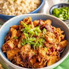 a bowl filled with meat and vegetables next to rice