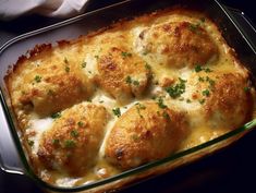 a casserole dish with meatballs and cheese