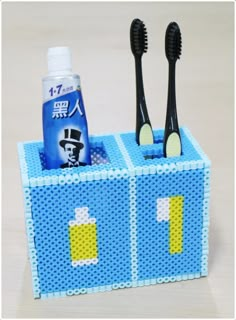 a lego toothbrush holder with two toothbrushes in it