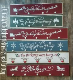 four wooden signs with christmas sayings on the front and back, all in different colors