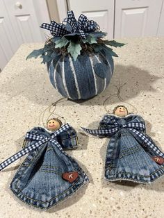 two denim angel ornaments sitting on top of a counter