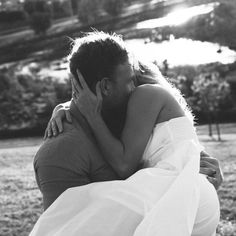 a man and woman hug each other in the park