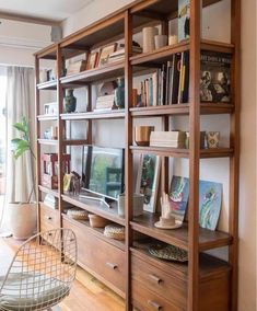 a living room filled with furniture and bookshelves next to a sliding glass door