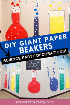 a science party decoration with giant paper beaks and flasks on the wall