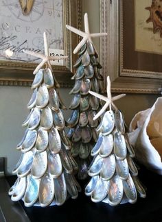 two small christmas trees made out of seashells