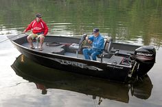 two men sitting in a boat on the water