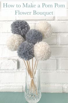 a vase filled with pom - poms on top of a table