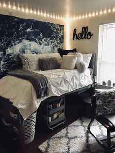 a bedroom with a bed, chair and lights on the wall above it that says hello