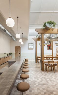 an empty restaurant with wooden tables and chairs