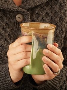 a woman holding a green cup in her hands