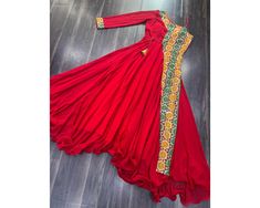 Red Anarkali Gown Navratri Gown Full Flared Long Gown Garba wear dress Indian festival Outfit Gown For navratri traditional gown 💃🏻 NAVRATRI COLLECTIONS-2024 🤳 This Red Coloured Attractive Partywear Gown will surely fetch you compliments for your rich sense of style, Grab this gown before someone else gets it and wear it Gown :-  Fabrics & Work :- Faux Blooming With Kutchi Gamthi Work.  Stitching :-  Standard Stitch With Wire-Picco and Drawstring  Length :- 56 Inch  Flair :- 4.5 Meter  Neck : Traditional Red Maxi Dress For Wedding, Traditional Floor-length Maxi Dress For Navratri, Traditional Red Maxi Dress For Eid, Traditional Red Maxi Dress, Red Floor-length Dress For Festivals, Red Maxi Dress For Eid Wedding, Red Floor-length Festival Dress, Red Maxi Dress For Wedding And Eid, Traditional Red Maxi Dress For Festive Occasions