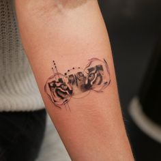 a woman's arm with a tattoo on it that says love and two cats