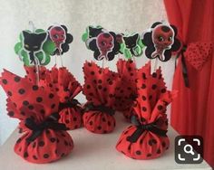 red and black polka dot candy bags with ladybug toppers on each one