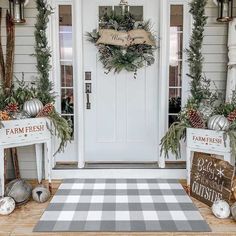 the front door is decorated for christmas with wreaths and decorations