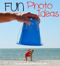 a person holding a blue bucket on top of a sandy beach next to the ocean