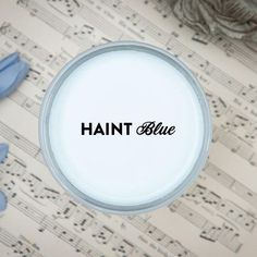 the word hait blue is in black on a white background with sheet music notes