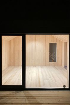 an empty room with wooden floors and walls