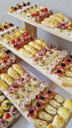 many different types of pastries are displayed on shelves