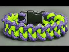 a purple and green bracelet with black buckle on grey background, close up view photo