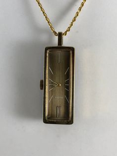 Nurse's Gift Vintage Mechanical Ladies Bulova Pendant Watch Necklace Variegated Copper Brown Color Dial white markers gold hands on reverse is a Blue Opaque Rectangular Glass with 24 inch gold tone chain 2.75 inch tall x 3/4 inch wide 1/2 inch thick Good to Good Plus Condition winds works Shipping included Pendant Watch, Pocket Watch Necklace, Copper Brown, Pendant Watches, Gold Hands, Watch Necklace, Nurse Gifts, Quartz Watch, Gold Watch