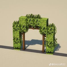 an arch made out of green plants and wooden posts