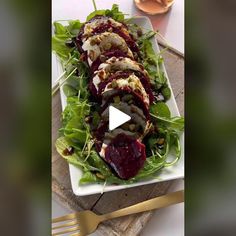 a white plate topped with lettuce and beets