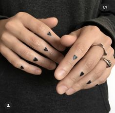 a person with two different rings on their fingers and one is holding the other hand