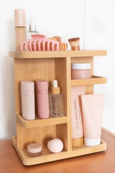 a wooden shelf filled with cosmetics and personal care items on top of a wood table