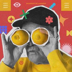 an old man holding two lemons in front of his eyes and looking through the lens