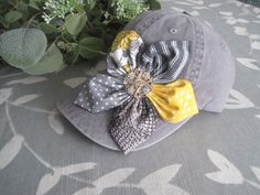 ALL ORDERS TOTALING OVER $35 SHIP FREE I designed this light grey trucker baseball cap making an adorable coordinating fabric petal flower. I added a beautiful matching rhinestone accent to the center of the flower.  This hat is so cute.  See more of my  hats here: http://www.etsy.com/shop/theraggedyrose?section_id=10557807 CUSTOM ORDERS ALWAYS WELCOME.... Will ship in 1 to 2 business days after payment is received.  Thanks for taking the time to stop by and look at my little shop. Hope you enjoyed. Thanks so much.  Contact me with any questions you may have. M Adjustable Gray Hat For Gift, Gray Adjustable Baseball Cap, Gray Snapback Hat For Spring, Gray Cap For Spring, Gray Spring Cap, Gray Brimmed Baseball Cap, One Size Fits Most, Gray Curved Brim Baseball Cap For Spring, Gray Baseball Cap For Spring, Gray Snapback Trucker Hat For Spring