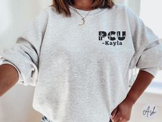 Custom PCU Sweatshirt, Personalized PCU Nurse Shirt with Name, PCU Nurse Gift, Progressive Care Unit Team Shirts, Nurse Appreciation Gift, Pcu Nurse Tech Tee ✧ SIZING ✧ ⋒ Please check our size chart before placing an order. ⋒ If you want an oversized look, pick a sweatshirt that is 2 sizes larger than your usual size. ✧ IMPORTANT NOTE: We try to depict all shirt and design colors as close to the original as possible but depending on your screen settings or the shirt color you chose, the colors of the graphics may vary slightly. If you're looking for a different size, color, or style to what we offer, please contact us and we will try our best to work something out. ✧ WHY YOU'LL LOVE IT ✧ ⋒ Highest quality sweatshirt for ultra-soft and comfortable wear. ⋒ The air-jet spun yarn and quarter-t Pcu Nurse, Nurse Tech, Bliss Products, Nurse Sweater, Nurse Appreciation Gifts, Nurse Sweatshirt, Nurse Appreciation, Nurse Shirt, One Drop