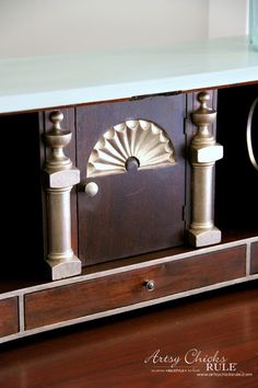 an old wooden cabinet with metal handles and knobs