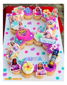 a birthday cake with cupcakes decorated like princesses