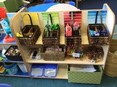 the shelves are filled with many different colored pens and pencils in baskets on them